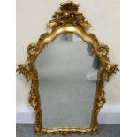 Gilt framed ornate wall mirror, height 102cm x width 68cm.