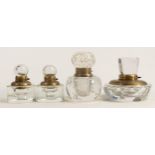 Four heavy glass crystal inkwells with brass fittings, tallest 9cm. (4)