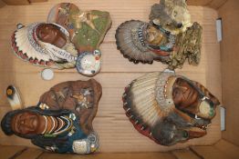 A group of 3 resin wall plaques depicting Native Americans together with a similar freestanding