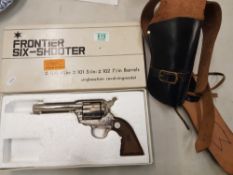 Frontier Six-Shooter replica pistol (original box) and leather holster.