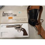 Frontier Six-Shooter replica pistol (original box) and leather holster.