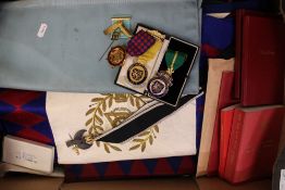 An interesting collection of masonic related items and regalia including aprons, sashes, medals