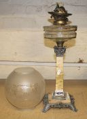 A neo classical Victorian oil lamp with an etched shade.
