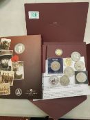 A small collection of coins including a 1oz fine silver Krugerrand and corresponding paperwork.