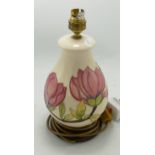 Moorcroft magnolia on cream lamp base. Height including fitting 28cm