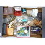 A good collection of vintage items including corkscrews, vintage Ronson fishing reel, set of marbles