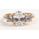 Tru Diamonds 3 stone trilogy ring with center stone measuring 9mm x 7mm ring size Q, with unknown