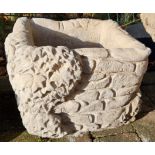 Stone garden ornament of a ivy brick planter, festooned with ivy