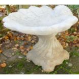 Stone garden ornament of a shell bird bath