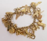 9ct gold charm bracelet with approx 32 9ct gold charms, 30.9g.