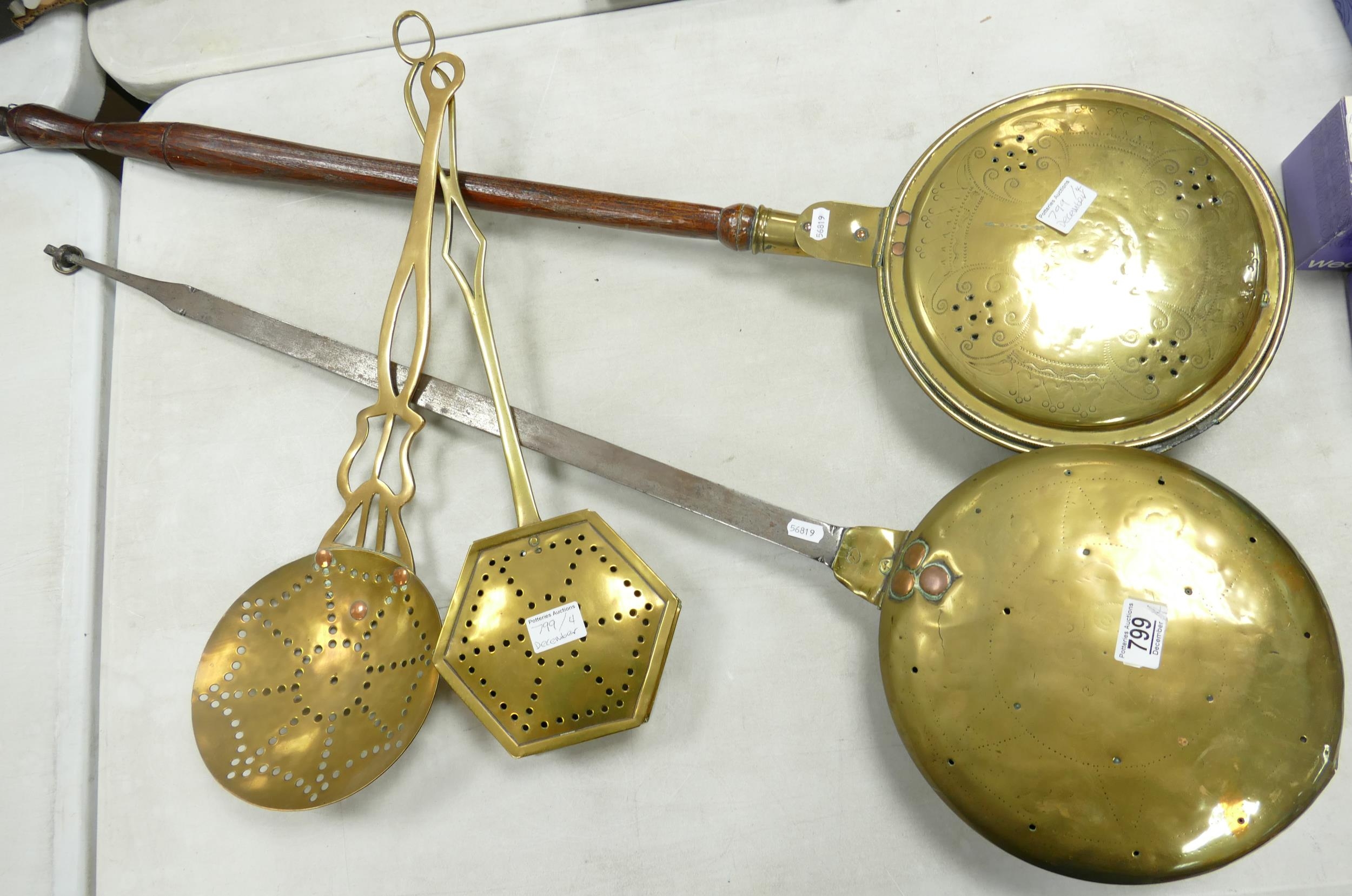 A collection of 19th century brassware to include 2 bed pans and two chestnut roasters. (4)