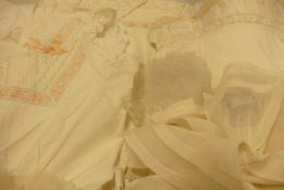 A collection of vintage lace /linen items to include night dresses, bonnet, runners, skirt