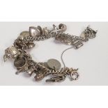 Silver charm bracelet, 63.7g.