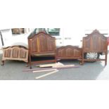 Two South African Hard Wood Carved Single Beds on ball & Claw Feet, with fittings, irons and slats(