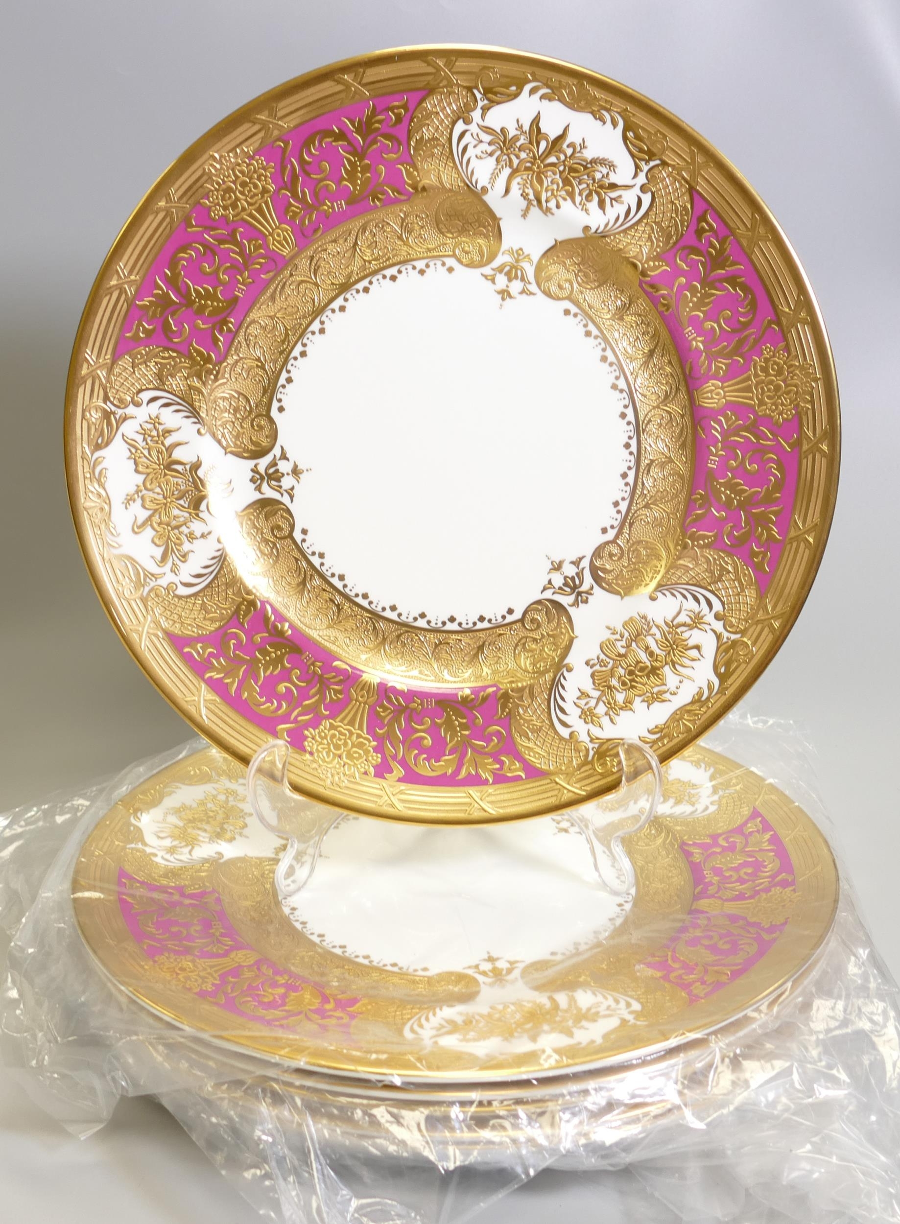 De Lamerie Fine Bone China heavily gilded Royale patterned Dinner plates in a pink / red colour,