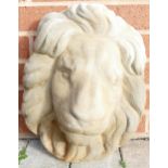 Stone garden ornament of a lion mask