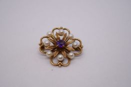 9ct yellow gold floral design brooch with central amethyst surrounded 8 seed pearls, marked 375, 3cm