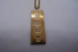 9ct yellow gold pendant in the form of a gold bar, marked 375 hung on a 9ct yellow gold belcher chai