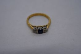 22ct yellow gold trilogy ring, set central square Sapphire, flanked with clear stones, marked 22ct,