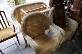 A modern cane effect settee with pair of chairs and table