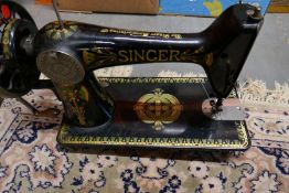 Two old sewing machines in oak cases