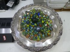 Silver plated dish containing marbles