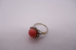 14K dress ring with peach hardstone surrounded clear stones, marked 14K