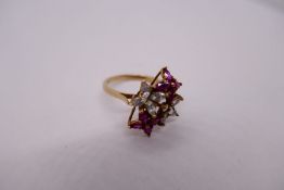 9ct yellow gold ruby and clear stone dress ring in the for of 4 flower heads, size N/O, marked 375,