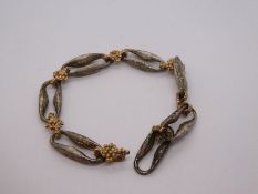 Chunky 9ct white and yellow gold bracelet each link separated by a gold nugget spacer,