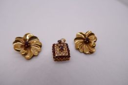Pair of 9ct yellow gold clap on earrings in the form of flower heads with central ruby and a 9ct rec