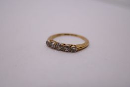 18ct yellow gold diamond ring, with 5 rubover set graduating diamonds, size O, marked 18, 2.5g appro