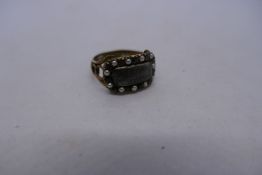 Unmarked yellow metal antique mourning ring with rectangular panel surrounded by amethyst and seed p