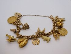9ct yellow gold charm bracelet hung with 11 9ct gold charms, half Sovereign charm 1902, and 2 non go