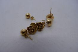 Three pairs of 9ct yellow gold stud earrings, including one pair in the form of flower heads, 5.7g a