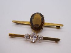 Two 9ct yellow gold bar brooches, one set with a large Smokey Topaz and the other clear stones, both