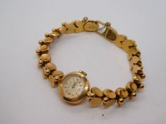 18ct yellow gold ladies cocktail watch by 'Movado' with safety chain, marked 750, 25.2g approx
