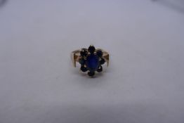 9ct yellow gold sapphire cluster ring in the form of a flower head, size P, marked 375, 3.3g