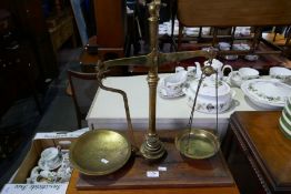 A set of brass balance scaled on Mahogany base by Avery