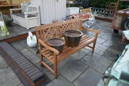 A modern garden bench and three garden pots