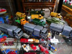 Shelf of Dinky playworn military vehicles (10)