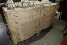 A pair of cream painted separate chest and having five drawers, and a pair of matching bedside table