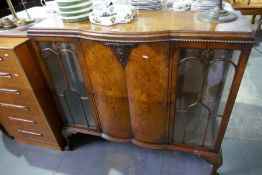 A 1930s Walnut display cabinet having central cupboard