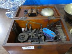 An early 20th Century alarm clock in walnut case