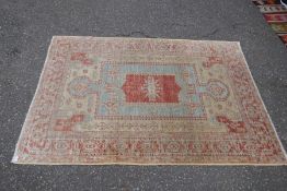 A geometric style rug having central stylized panel 221cm x 153cm