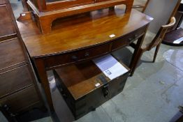 An old mahogany bow fronted side table having two drawers with a box base dressing mirror and glazed