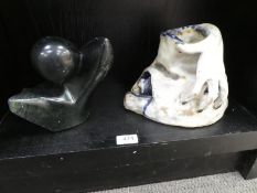 An art pottery sculpture of hand and two heads and a marble sculpture