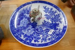 A large blue and white glazed oriental style charger and teapot