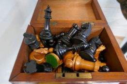 Selection of various wood and resin chess pieces, some weighted, in box