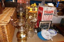 Collection of vintage brass and other oil lamps, copper kettles, Tilley Lamps, wicker hamper etc