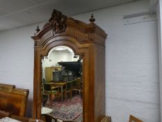 An antique French Walnut Wardrobe having single mirrored door with carved surmount 104cm wide